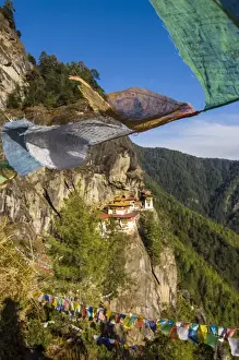 Images Dated 11th April 2009: Praying flags before the Tiger-Nest, Taktshang Goempa monastery hanging in the cliffs