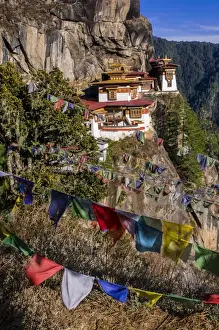 Images Dated 11th April 2009: Praying flags before the Tiger-Nest, Taktshang Goempa monastery hanging in the cliffs