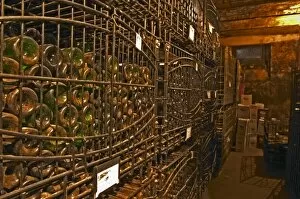 The private bottle aging cellar with hundreds, thousands of bottles in metal wrought