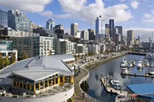 Sky Scraper Prints: Puffy clouds over Seattle, Washington skyline seen from Elliot Bay with boats in the foreground