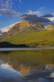 Rainbow Peak reflects in Bowman Lake in Glacier National Park, Montana, USA
