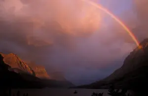 Crater Prints: Rainbow and stormy sunrise over St. Mary Lake in Glacier National Park, Montana