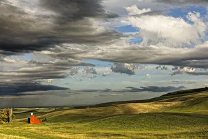 Prints of Red barn in valley of rolling farm fields, Palouse agricultural region of western Idaho Images Dated 2020 February: Red barn in valley of rolling farm fields, Palouse agricultural region of western Idaho