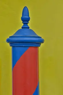 Striped Prints: Red & Blue painted and stripped pole with Yellow Home as backdrop, Burano Italy