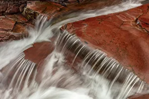 Red Rock Prints: Red rocked bottom of Virginia Creek in Glacier National Park, Montana, USA
