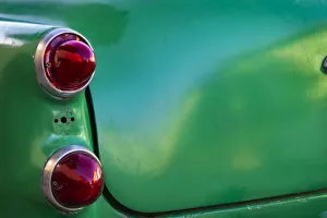 Classic Car Prints: Detail of two red tail lights on classic green car in Trinidad, Cuba