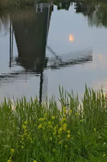 Reflection of windmills in the water along the canal in Kinderdijk, Netherlands