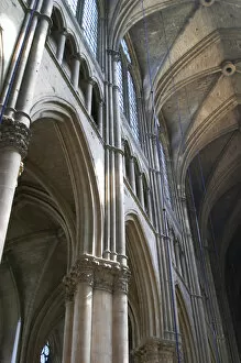 The Reims cathedral with its high gothic arched vaults and sun shining through the