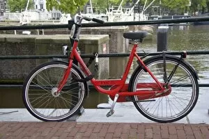 Images Dated 25th July 2007: Rental bicycle parked along the Amstel River in Amsterdam, Netherlands