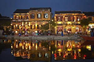 Dark Prints: Restaurants and tourists reflected in Thu Bon River at dusk