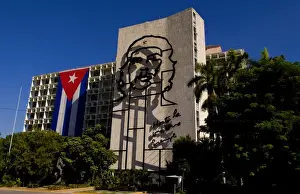Hero Prints: Revolution Square in Havana Cuba with large neon artwork of Che on wall and Cuban flag
