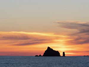 Prints of Rialto Beach, Olympic Peninsula, Washington State. Seastack silhouetted at sunset Images Dated 2024 September: Rialto Beach, Olympic Peninsula, Washington State. Seastack silhouetted at sunset