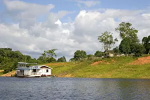 Images Dated 21st January 2007: River boat and house on the Arasa River in the Amazon jungle near Manaus, Brazil