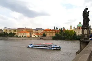 Images Dated 8th August 2020: River boat on Vitava River and the famous Charles Bridge of tourist city of Prague
