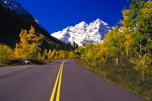 Road lined with autumn colors and Maroon Bells