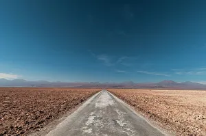 Vast Prints: An empty road through a salt flat in the Salar de Atacama