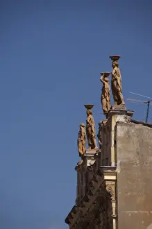 Brasov Prints: Romania, Transylvania, Brasov. Architectural detail of rooftop statues in downtown Brasov