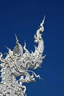 Rooftop architectural detail of dragon head on the new all white temple of Wat Rong