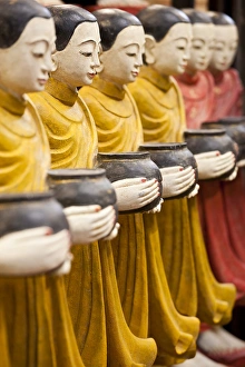 Bowl Prints: Row of Buddhist monk statues holding alms bowls, Weekend Market, Bangkok, Thailand
