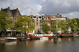 Row houses along the Amstel River in Amsterdam, Netherlands