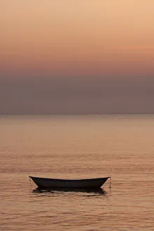 Copy Space Prints: Rowboat at anchor in the water at sunset