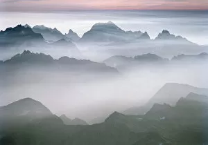 The rugged peaks of North Cascades National Park seen through mist with a band of
