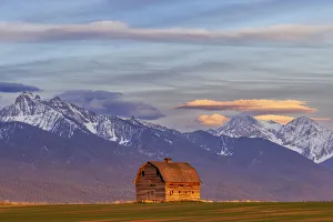 Mission Valley Prints: Rustic old barn in evening light with Mission Mountains in Pablo, Montana, USA