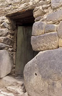 SA, Peru, Ollantaytambo Front entrance to home with large and small stones