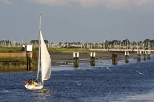 A sail boat at Nieuwpoort harbor entrance in the province of West Flanders, Belgium