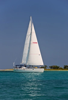 Magical Prints: A sail boat sailing by Laughing Bird Cay in Belize