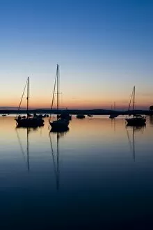Sailboats in the Connecticut River after sunset in Old Lyme, Connecticut