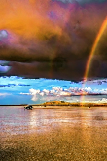 Rainbow Prints: Salar de Uyuni, Bolivia. Vertical landscape view of rainbow appearing at sunset over the Salar de Uyuni