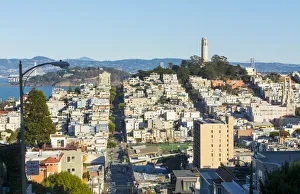San Francisco California hills of the city and Coit Tower in sunshine with streets
