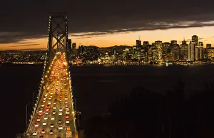 Images Dated 2029: San Francisco California skyline and the Oakland Bay Bridge at evening with traffic on bridge