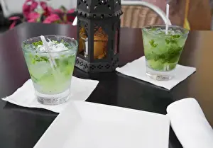 Old San Juan Prints: San Juan, Puerto Rico - Two alcoholic beverages are sitting on a table next to a lantern