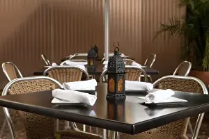 San Juan, Puerto Rico - A lamp is sitting on a restaurant table unlit. Surrounding