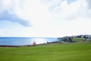Old San Juan Prints: San Juan, Puerto Rico - A large grassy area stretches out leading to a stone wall