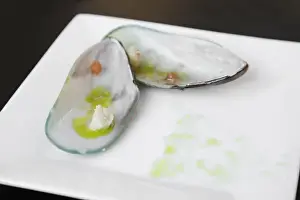Old San Juan Prints: San Juan, Puerto Rico - A mussel is set open on a square plate and drizzled with olive oil