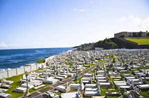 Old San Juan Prints: San Juan, Puerto Rico - Tombs and religious statuary mark graves in a cemetery near the ocean