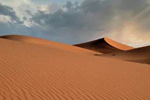 Rissani Prints: Sand dunes glow orange at sunset in the Sahara Desert