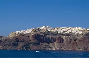 Images Dated 30th August 2021: Santorini Greece and the beautiful white buildings on the mountain cliffs from a ship