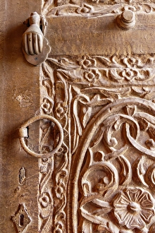 Saudi Arabia, Mecca, Jeddah, Al-Balad. Metal pull and knocker on a carved wooden door in the Al-Balad historical district