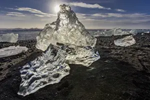Scattered ice from icebergs on black sand beach at Joklusarlon, Iceland