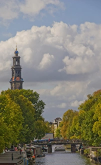 Scenic Canal view with bridge and the Zuiderkerk clock and spire in the distance Scenic Canal view with bridge and the Zuiderkerk clock and spire in the distance