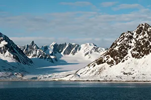 A scenic view of ice covered mountains and an ice field off Magdalenefjorden, Spitsbergen Island, Svalbard, Norway