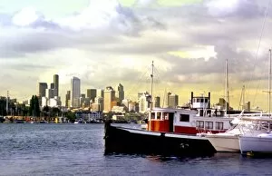 Seattle skyline frames a wooden boat on Lake Union