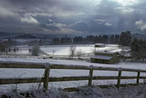 Images Dated 3rd July 2007: Shaft of light hits the snow-covered rural pasture with horses and barns near Lake Oswego