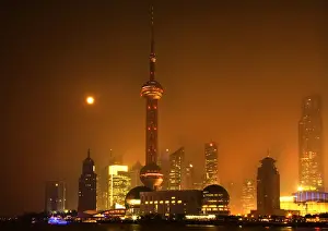 Shanghai Prints: Shanghai Pudong Chna Skyline at Night with TV Tower with Moon and Reflections Orange