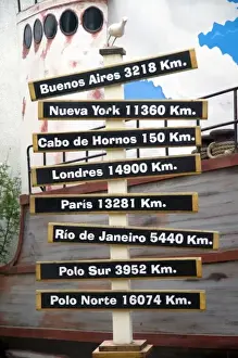Ushuaia Prints: Sign showing distances in kilometers from Ushuaia on the island of Tierra del Fuego