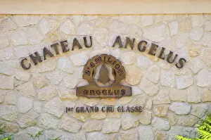 Roadsign Prints: Sign on stone wall saying Chateau Angelus 1er premier first cru classe Saint Emilion